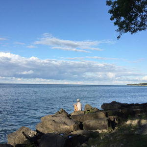 Un homme assis au bord du lac Ontario