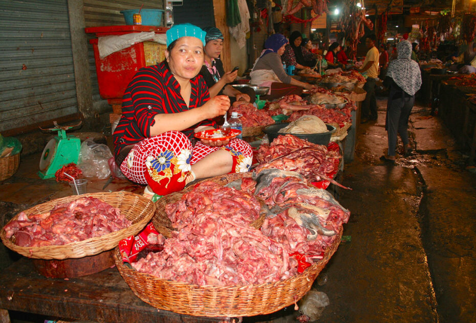 Vendeuse de viande qui se restaure en attendant les clients