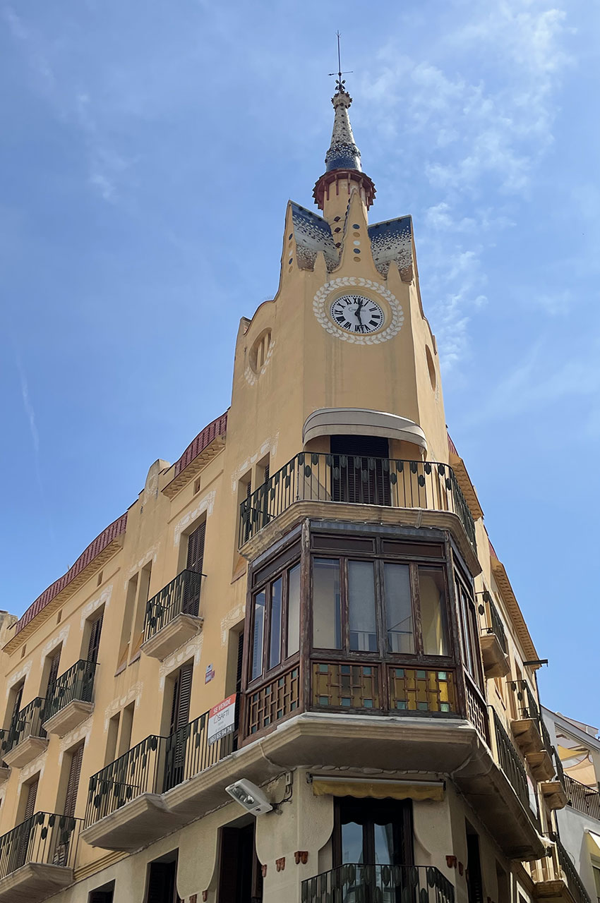 Immeuble avec horloge dans la rue commerçante, Plaça Cap de la Vila