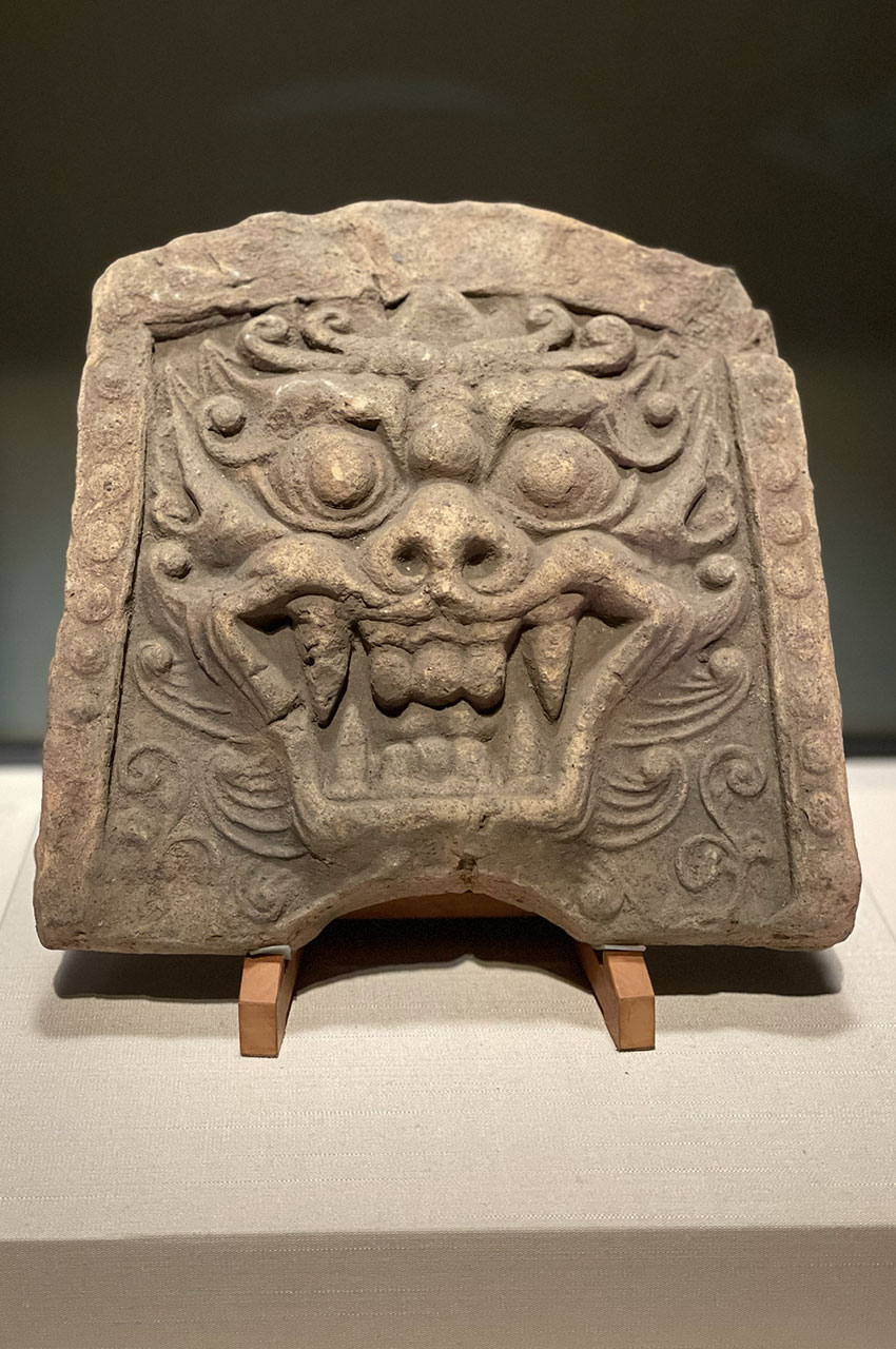 Tuile décorative représentant un visage de démon Tuile décorative représentant un visage de démon